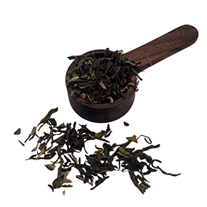 Loose Ginkgo green tea leaves in a wooden scoop