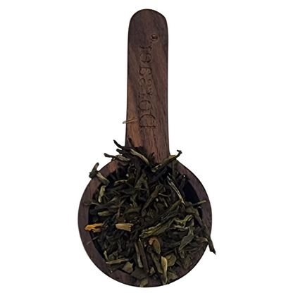 Loose Ginkgo green tea leaves in a wooden scoop